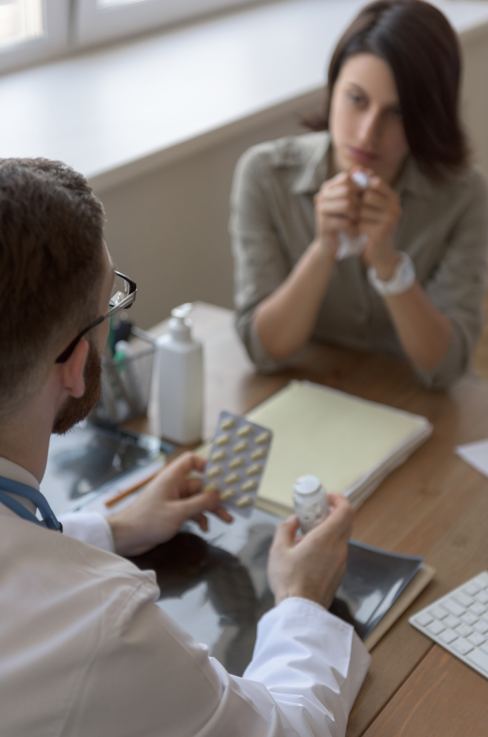 Pharmacist prescribing for sick woman with flu 